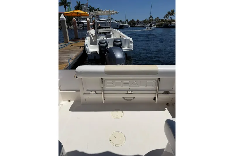 Slide: The Image of 2015 Robalo R227 Dual Console boat docked by the water. - 9