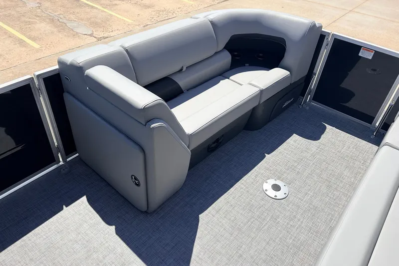 Slide: The Image of 2026 Sun Tracker Party Barge 22 DLX interior with gray seating and spacious deck. - 12