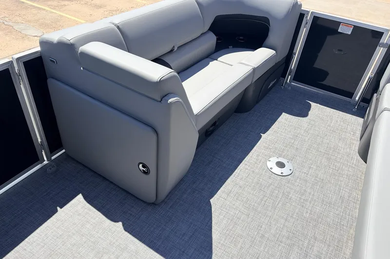 Slide: The Image of 2026 Sun Tracker Party Barge 22 DLX interior with gray seating and flooring. - 18