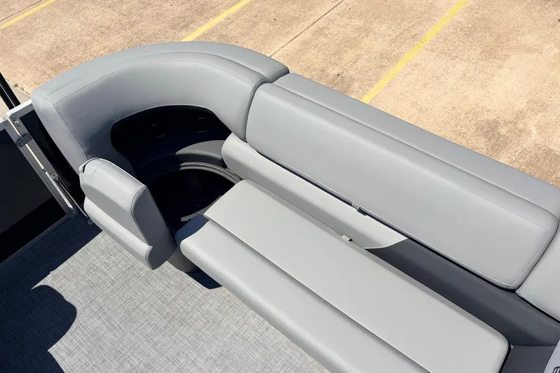 Slide: The Image of 2026 Sun Tracker Party Barge 22 DLX, featuring sleek gray seating and modern design. - 23