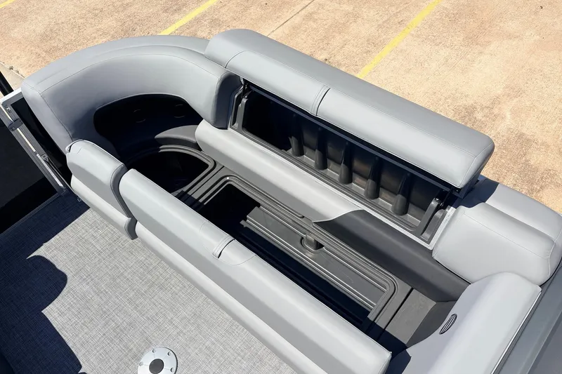 Slide: The Image of 2026 Sun Tracker Party Barge 22 DLX interior seating with storage compartments. - 25