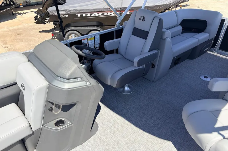 Slide: The Image of 2026 Sun Tracker Party Barge 22 DLX interior with plush seating and modern helm. - 29