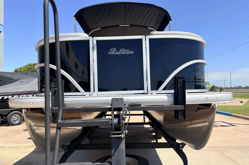 Slide: The Image of 2026 Sun Tracker Party Barge 22 DLX pontoon boat on trailer, front view. - 3