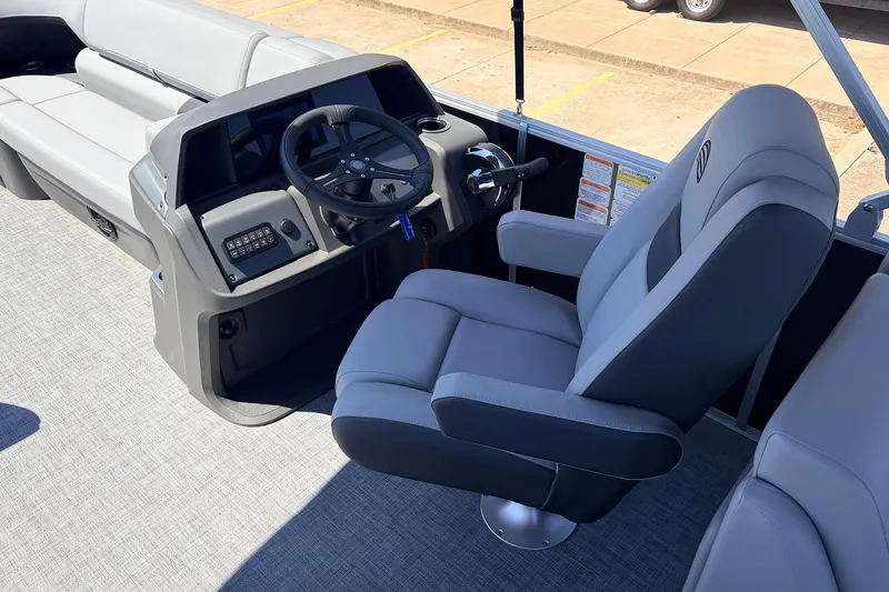 Slide: The Image of 2026 Sun Tracker Party Barge 22 DLX interior with steering console and plush seating. - 31