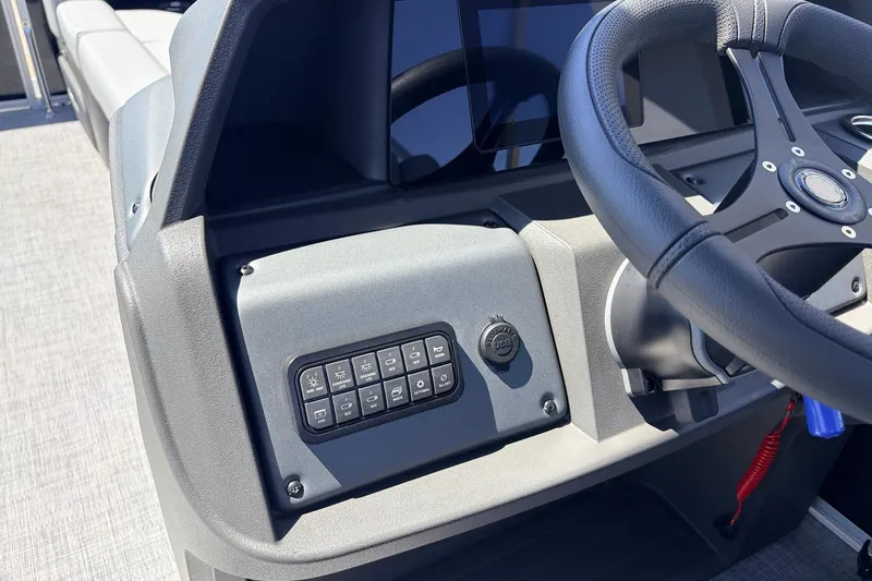 Slide: The Image of 2026 Sun Tracker Party Barge 22 DLX dashboard with steering wheel and control panel. - 33