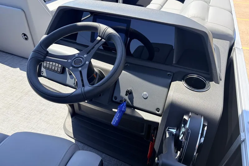 Slide: The Image of 2026 Sun Tracker Party Barge 22 DLX steering console with modern controls and seating. - 34