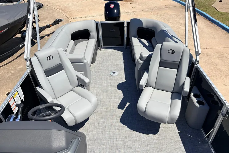 Slide: The Image of 2026 Sun Tracker Party Barge 22 DLX interior with gray seating and steering wheel. - 36