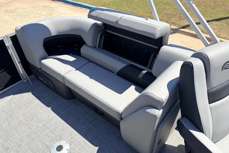 Slide: The Image of 2026 Sun Tracker Party Barge 22 DLX interior with gray seating and storage compartment. - 38