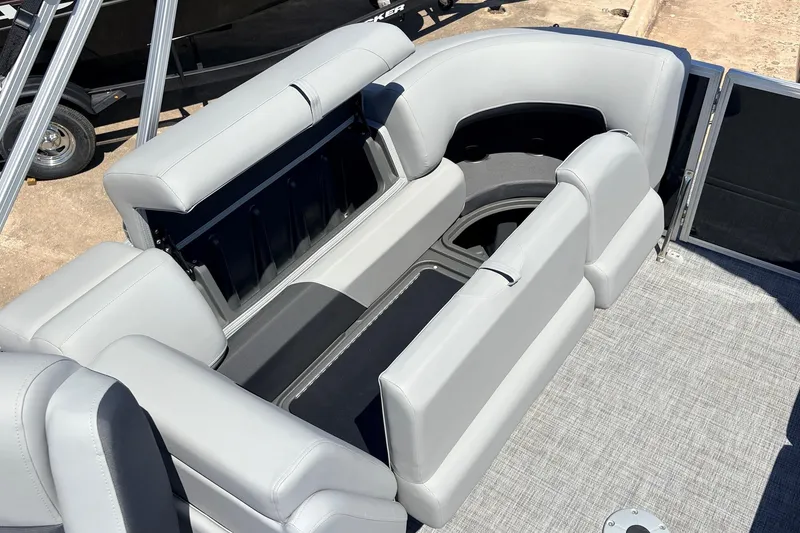 Slide: The Image of 2026 Sun Tracker Party Barge 22 DLX interior seating with storage compartments. - 48