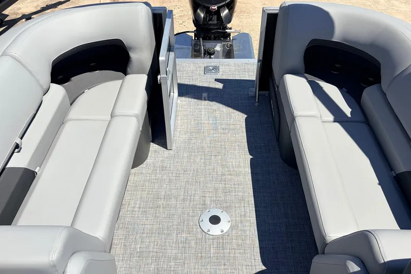 Slide: The Image of 2026 Sun Tracker Party Barge 22 DLX interior with gray seating and open deck space. - 49