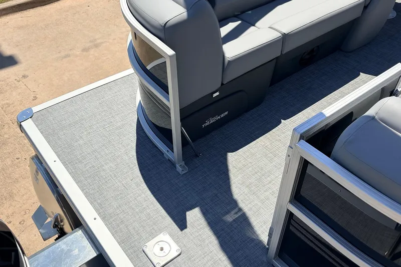 Slide: The Image of 2026 Sun Tracker Party Barge 22 DLX pontoon boat interior with gray seating and flooring. - 50