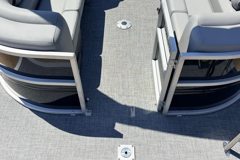 Slide: The Image of 2026 Sun Tracker Party Barge 22 DLX interior with gray seating and open gate. - 51