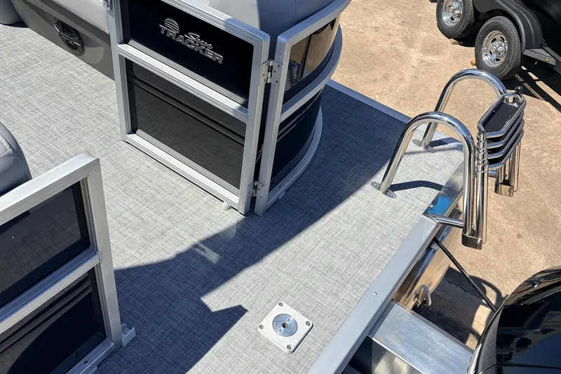 Slide: The Image of 2026 Sun Tracker Party Barge 22 DLX pontoon boat deck with ladder and railing. - 52