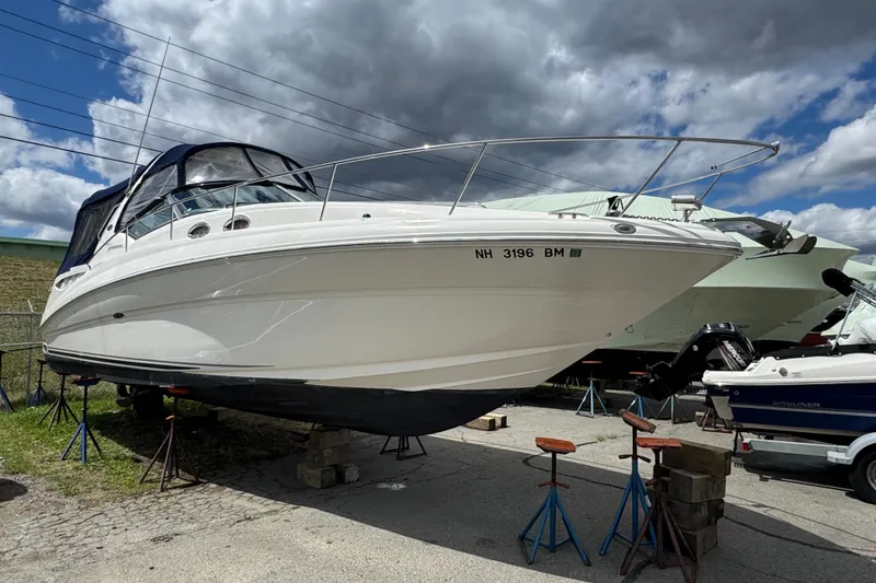 The Image of 2007 Sea Ray Sundancer 320 boat on stands under cloudy sky. - 0