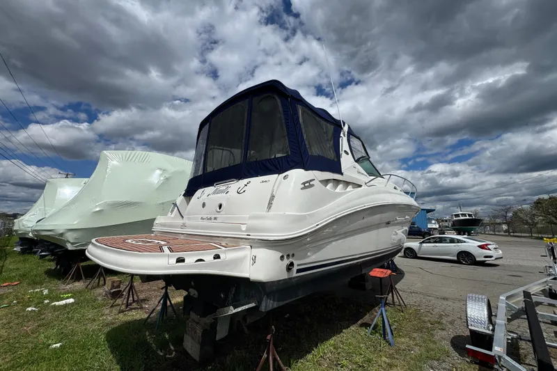 Slide: The Image of 2007 Sea Ray Sundancer 320 yacht on stands under cloudy sky. - 1