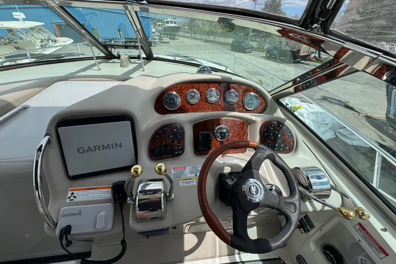 Slide: The Image of Cockpit of 2007 Sea Ray Sundancer 320 with Garmin navigation system and wood-accented dashboard. - 11