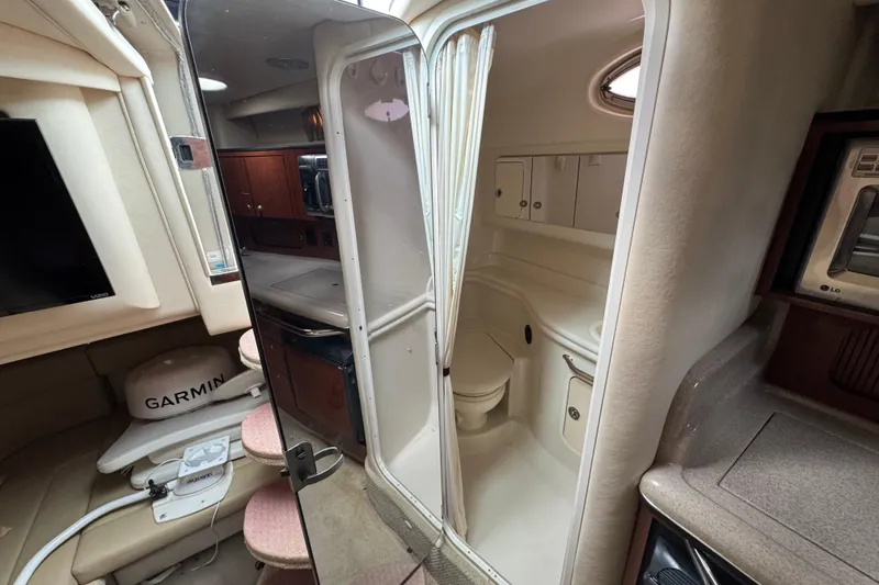 Slide: The Image of Interior of 2007 Sea Ray Sundancer 320 yacht, featuring a compact bathroom and kitchenette. - 12