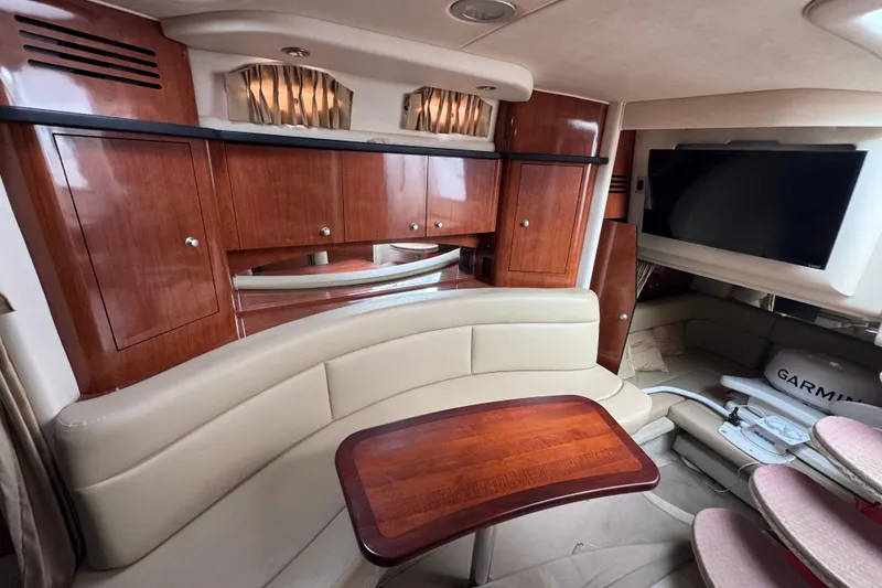 Slide: The Image of Luxurious interior of 2007 Sea Ray Sundancer 320 with wood cabinetry and seating area. - 13