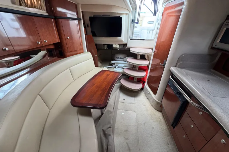 Slide: The Image of Interior of 2007 Sea Ray Sundancer 320 yacht with seating, table, and cabinetry. - 15