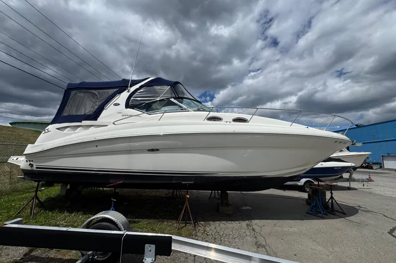 Slide: The Image of 2007 Sea Ray Sundancer 320 boat on stands under cloudy sky. - 2