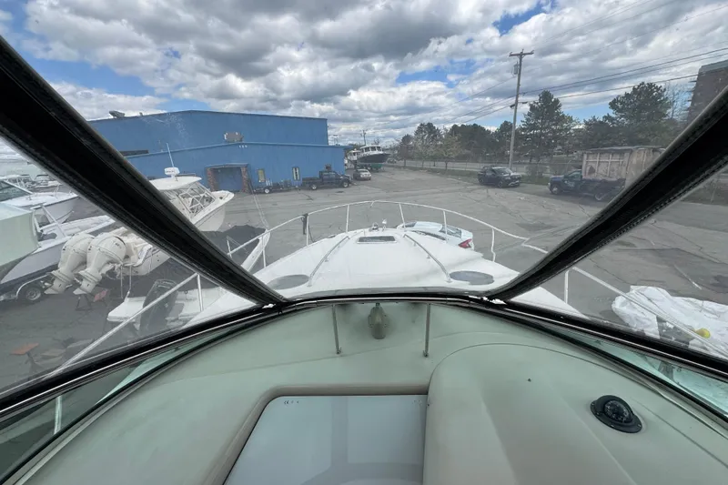 Slide: The Image of 2007 Sea Ray Sundancer 320 cockpit view in a marina with cloudy sky. - 4