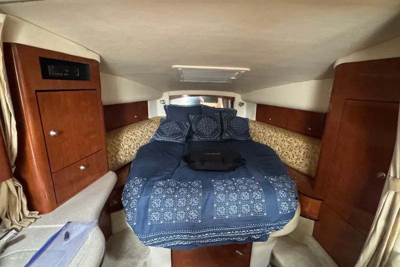 Slide: The Image of Interior cabin of 2007 Sea Ray Sundancer 320 with cozy bed and wooden cabinetry. - 7