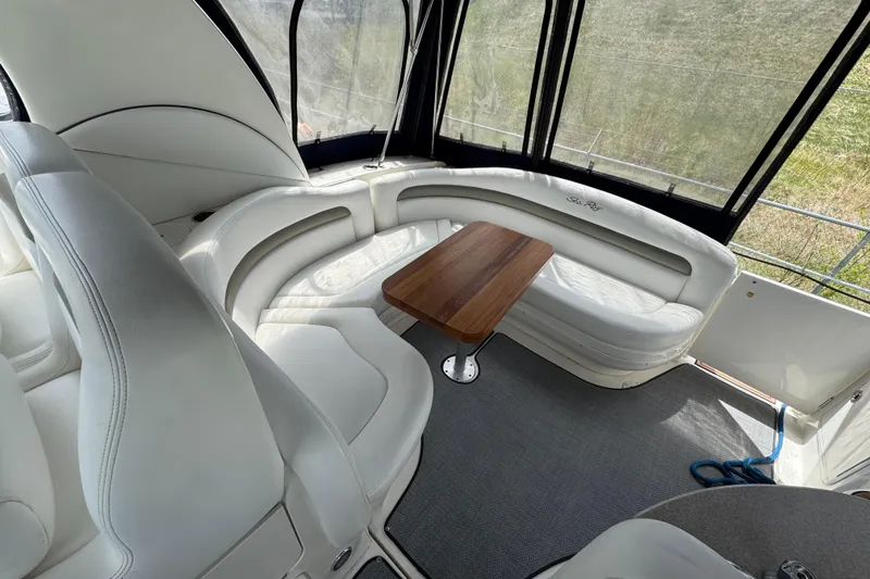 Slide: The Image of Luxurious interior of 2007 Sea Ray Sundancer 320 with white seating and wooden table. - 8