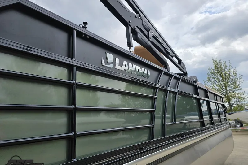 Slide: The Image of 2026 Landau Signature 25C pontoon boat with sleek black exterior design. - 10