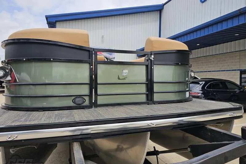 Slide: The Image of 2026 Landau Signature 25C pontoon boat at a dealership, showcasing sleek design and seating. - 13