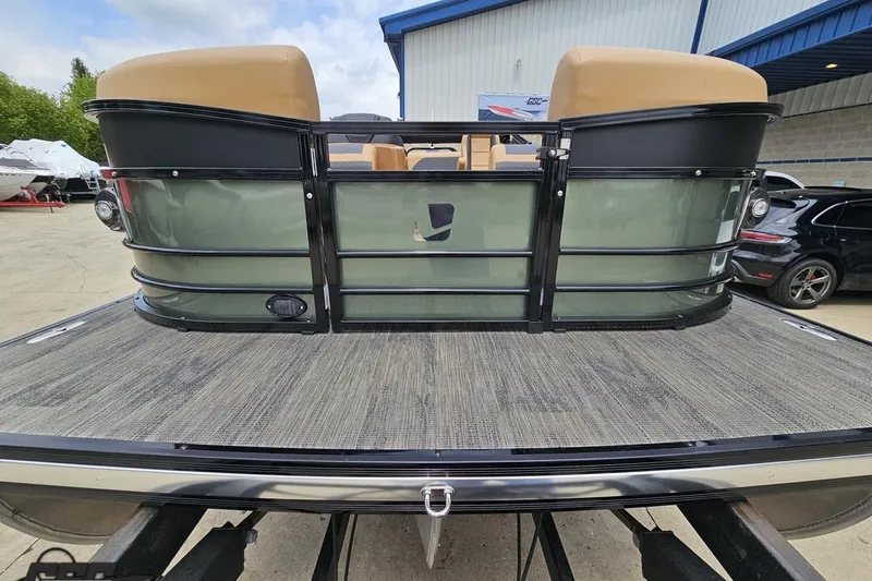 Slide: The Image of 2026 Landau Signature 25C pontoon boat with beige seating, docked at a marina. - 15
