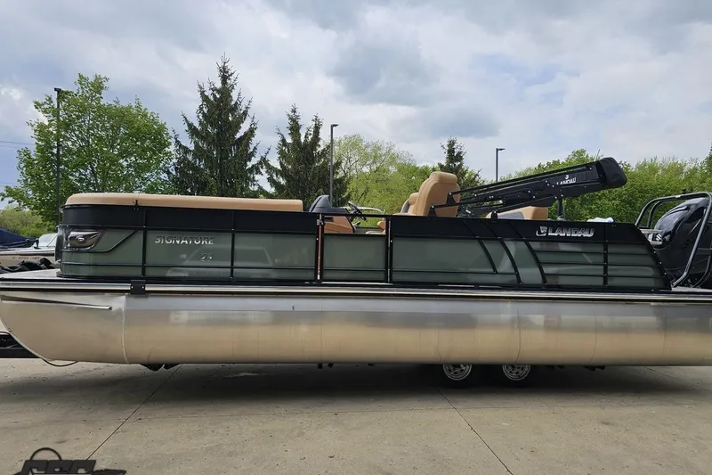 Slide: The Image of 2026 Landau Signature 25C pontoon boat on trailer, parked outdoors. - 24