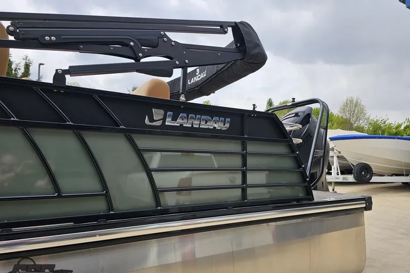 Slide: The Image of 2026 Landau Signature 25C pontoon boat with sleek black design and modern features. - 26