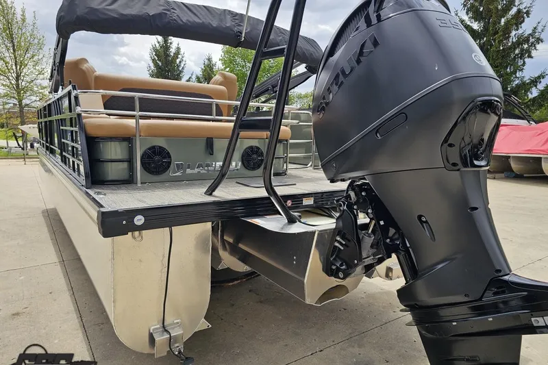 Slide: The Image of 2026 Landau Signature 25C pontoon boat with Suzuki outboard motor, docked outdoors. - 31