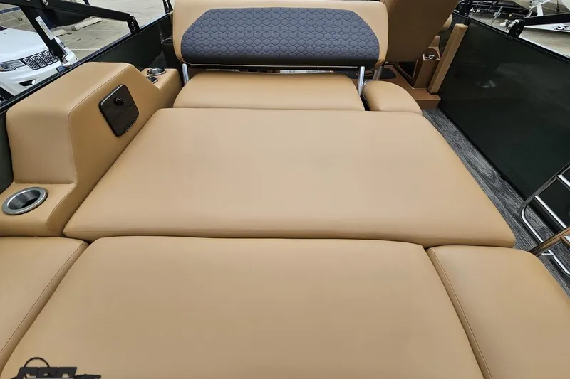 Slide: The Image of 2026 Landau Signature 25C boat interior with tan leather seating and cup holders. - 43