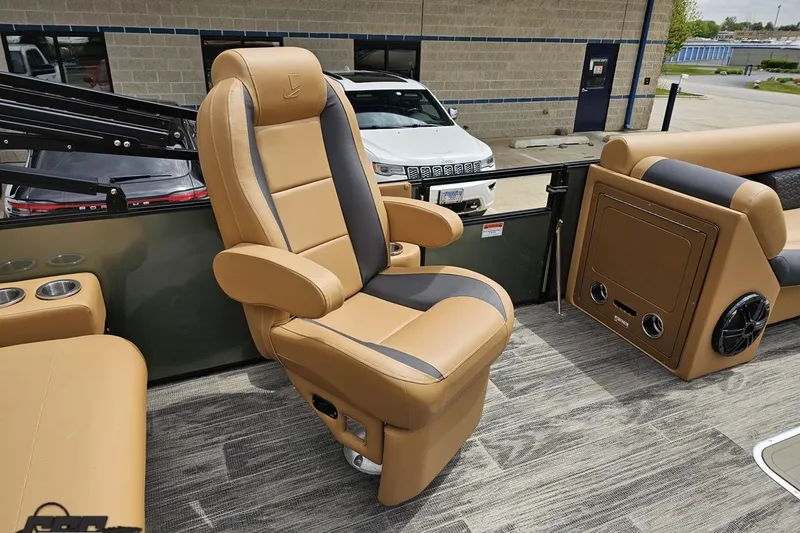 Slide: The Image of Luxurious seating on 2026 Landau Signature 25C pontoon boat, featuring tan and gray upholstery. - 49