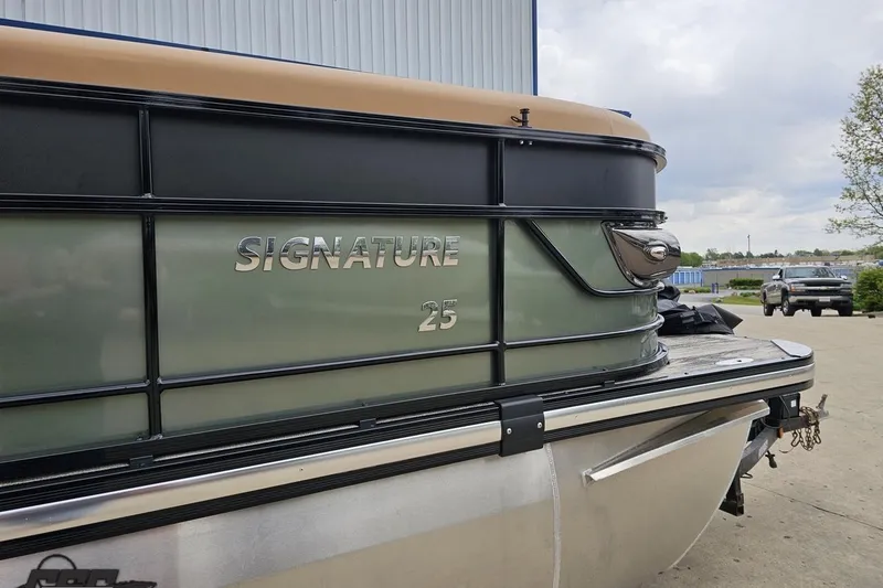 Slide: The Image of 2026 Landau Signature 25C pontoon boat, sleek design, parked outdoors. - 5