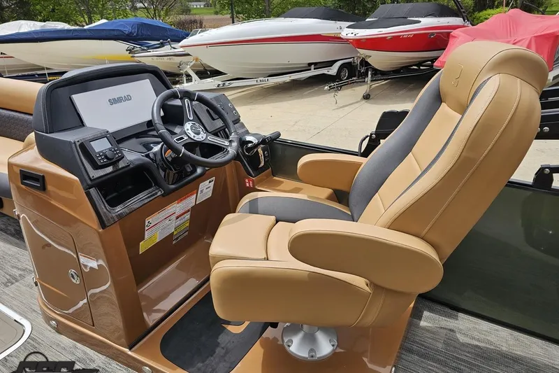 Slide: The Image of Captain's chair and helm of 2026 Landau Signature 25C boat, featuring modern controls and steering. - 51
