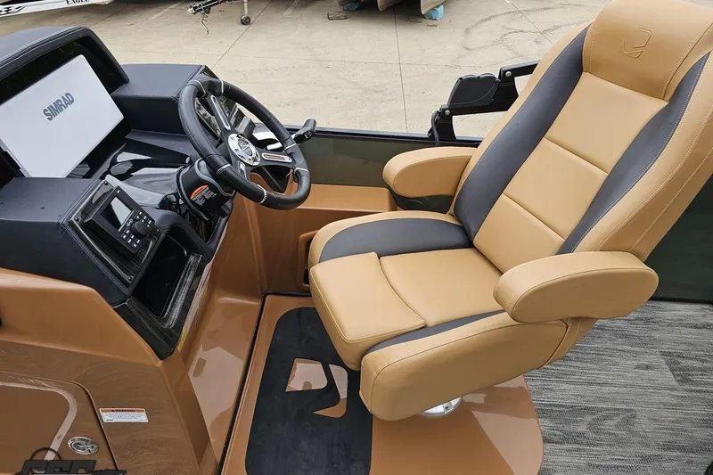 Slide: The Image of Captain's chair and helm of 2026 Landau Signature 25C boat, featuring modern controls and navigation. - 52