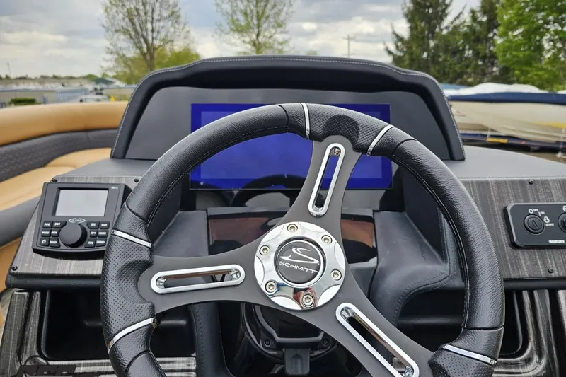 Slide: The Image of Steering wheel and dashboard of 2026 Landau Signature 25C boat, featuring modern controls. - 53