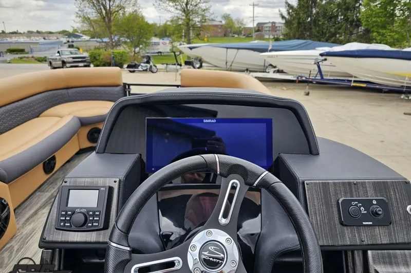 Slide: The Image of 2026 Landau Signature 25C boat dashboard with steering wheel and navigation display. - 54