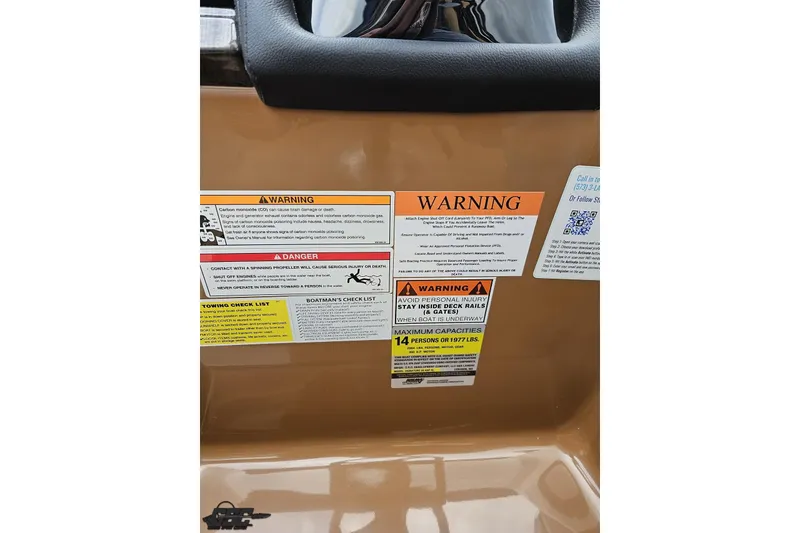 Slide: The Image of Warning labels on 2026 Landau Signature 25C boat, highlighting safety precautions and capacity limits. - 55