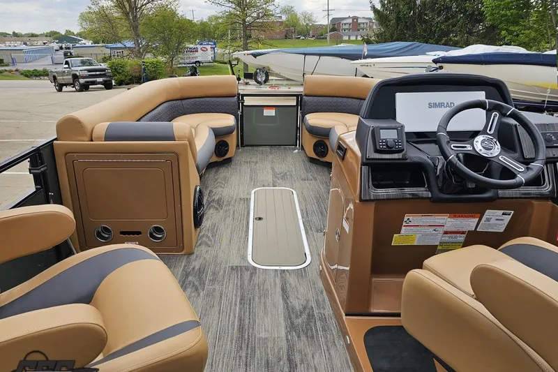 Slide: The Image of 2026 Landau Signature 25C pontoon boat interior with tan seating and modern dashboard. - 56