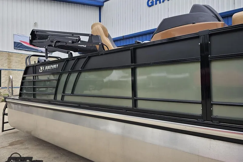 Slide: The Image of 2026 Landau Signature 25C pontoon boat with sleek black and beige design, docked outdoors. - 6