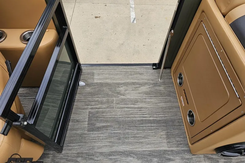 Slide: The Image of Interior view of 2026 Landau Signature 25C boat with open door and cup holders. - 60