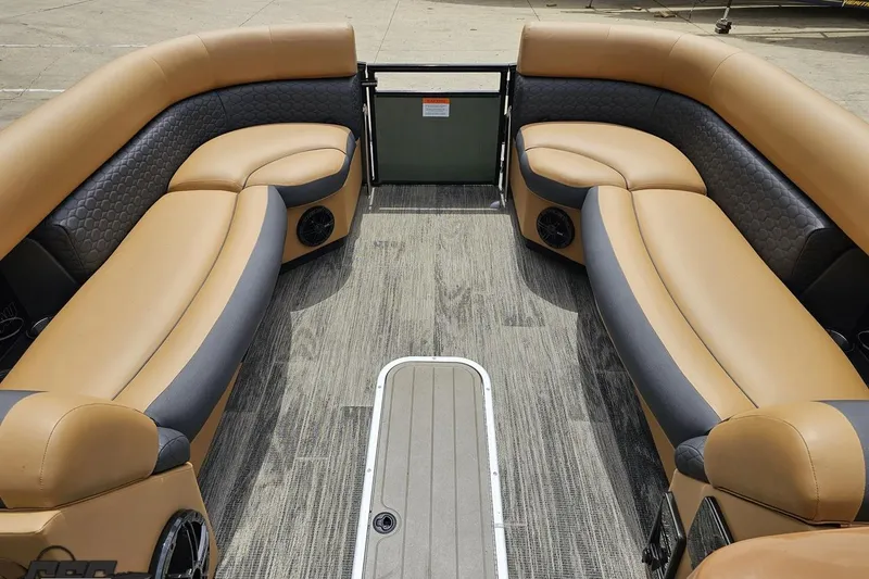 Slide: The Image of Interior of 2026 Landau Signature 25C pontoon boat with luxurious tan and black seating. - 61
