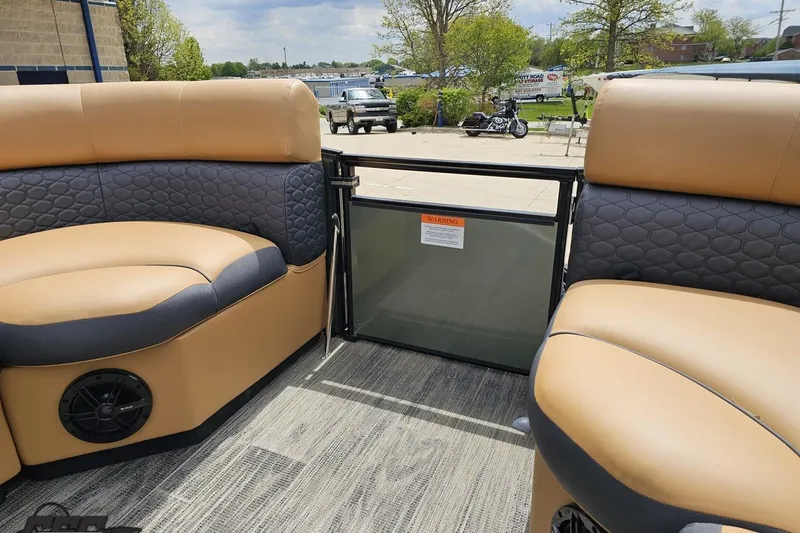 Slide: The Image of Interior of 2026 Landau Signature 25C pontoon boat with tan and gray seating. - 64