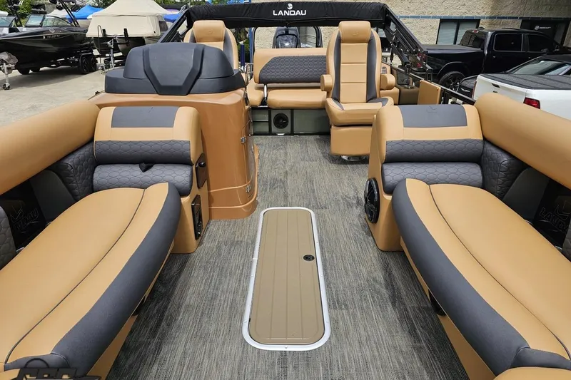 Slide: The Image of 2026 Landau Signature 25C pontoon boat interior with luxurious tan and gray seating. - 67