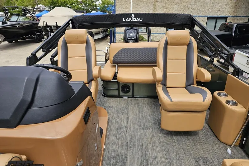 Slide: The Image of Interior of 2026 Landau Signature 25C pontoon boat with tan and gray seating. - 69