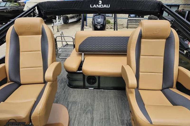 Slide: The Image of Interior of 2026 Landau Signature 25C boat with tan and gray seating. - 70