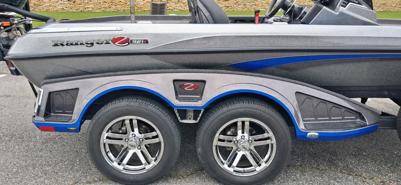 Slide: The Image of 2024 Ranger Z521R boat with dual axle and shiny rims. - 14